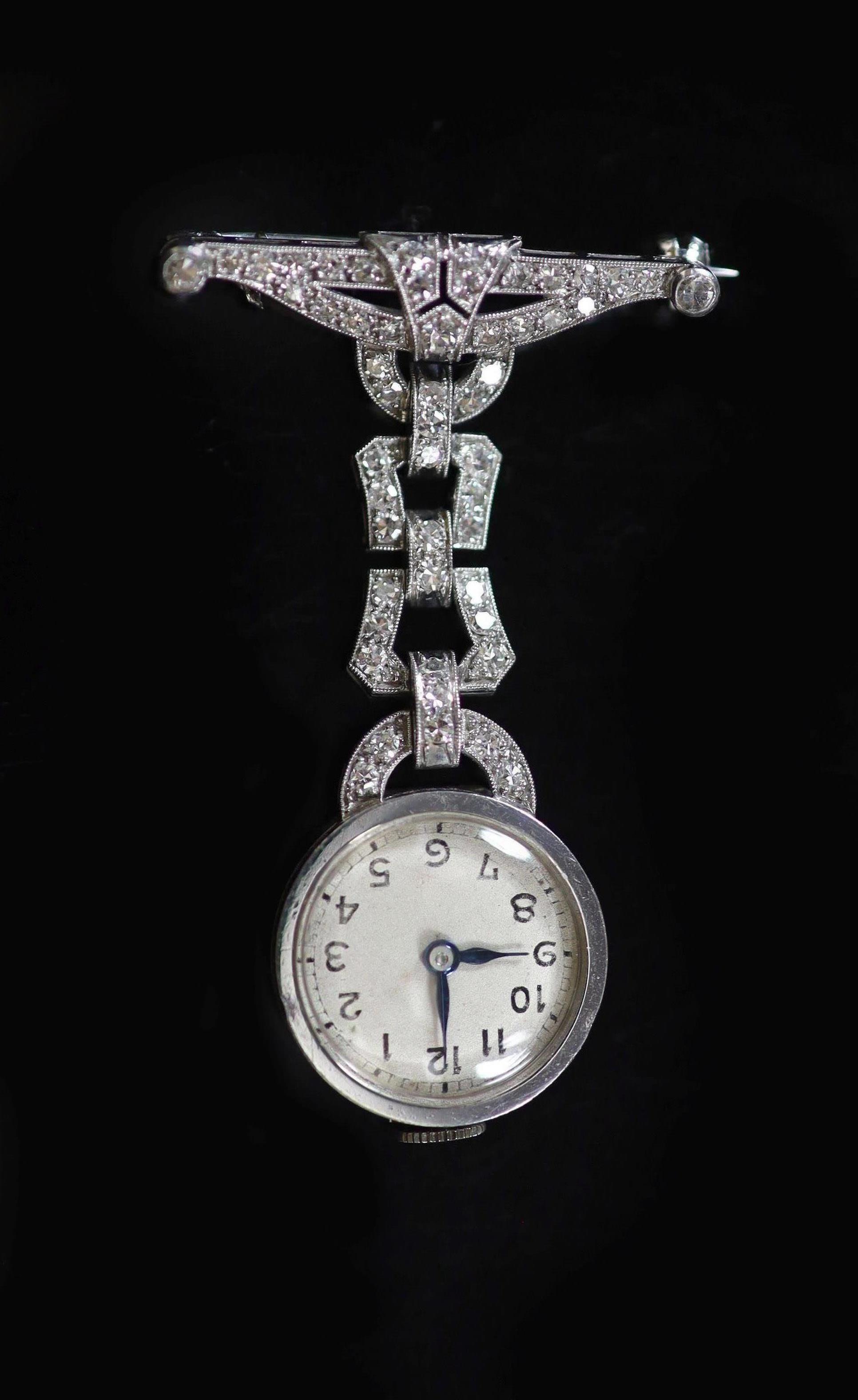 A lady's 1940's platinum and millegrain diamond set lapel watch